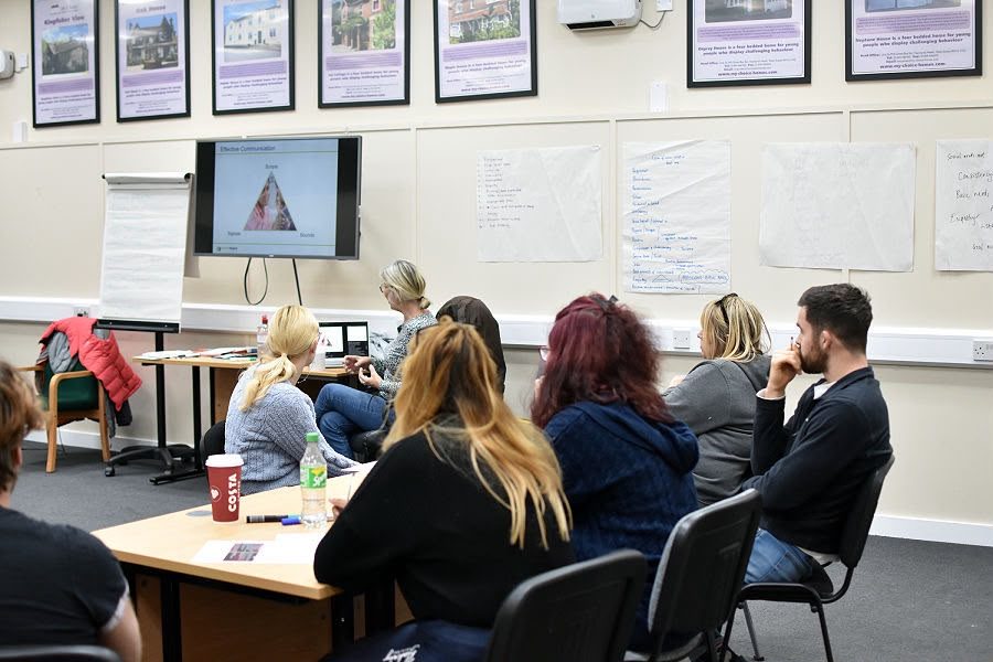 A group of care staff taking part in a training session